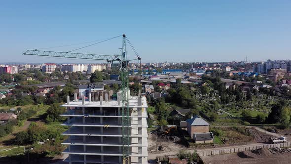 Workers work with crane and steel concrete reinforcement at large construction alt