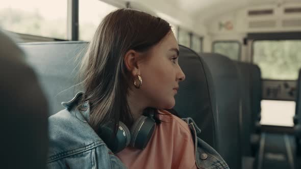 Teenage Girl Sitting School Bus Close Up alt