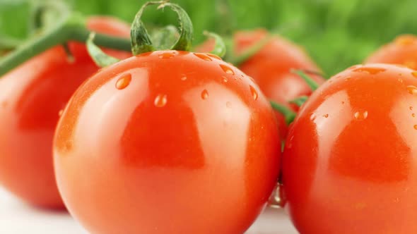 Cherry tomatoes close-up. Rotating on a green background Macro shot. Garden alt