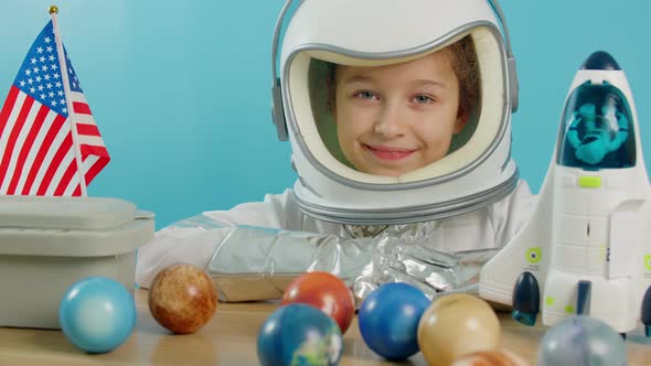 Little Girl 89 Years Old in an Astronaut Costume Smiling Happy Child Looking at the Camera Closeup alt