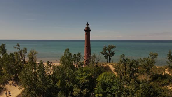4k drone video of Little Sable Lighthouse in Silver Lake, Michigan in the summer. alt