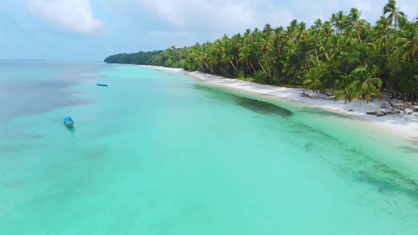 Aerial: woman relaxing on white sand beach turquoise water tropical alt