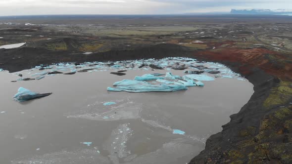 Aerial View of Icebergs Melting in Glacial Lake Water in Highlands of Iceland.  Climate Change and G alt