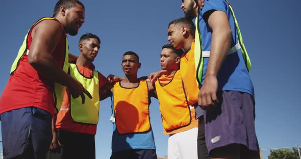 Soccer players planning strategy on the field alt