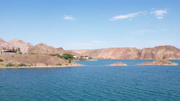Flying Over a Lake with Islands and Rocks alt