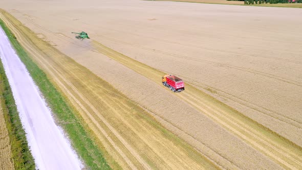 An Aerial View of the Red Truck and the Harvester in Estonia