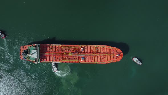 Aerial View of Tanker Ship with Escorting Tug Leaving Port alt