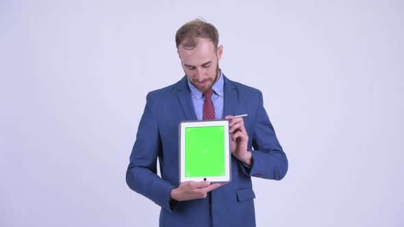 Happy Bearded Businessman Presenting with Digital Tablet