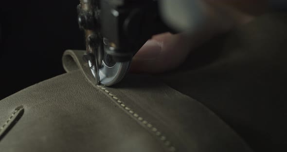 Tailor Works on Sewing Machine in Private Leather Craftshop Making Shoes in Process