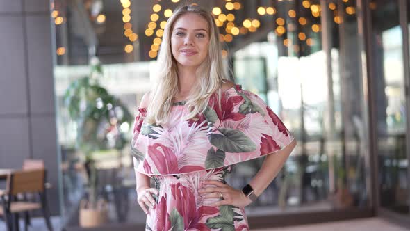 Cheerful Woman Standing Outside Restaurant alt