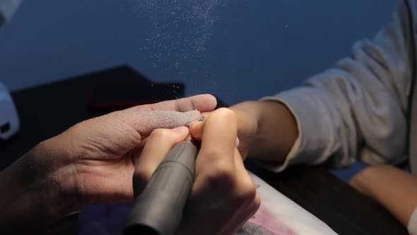 Anonymous Beautician Doing Manicure to Female Client