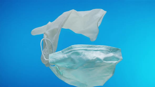 Medical Mask and Gloves in Ocean Coronavirus Covid 19 Plastic Trash in Water Sea Pollution Ecology alt