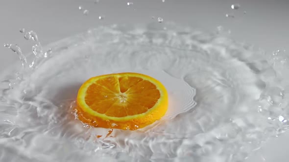 Piece of Orange Falls Into the Water