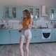 A Beautiful Woman in White Shorts is Relaxing at Home Dancing in the Kitchen - VideoHive Item for Sale