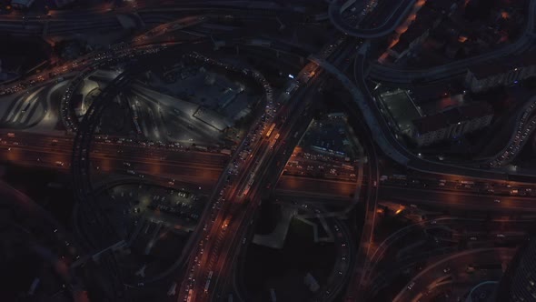 Big Interstate Freeway Connection with Traffic Jam at Night, Aerial Birds Eye Overhead Drone alt