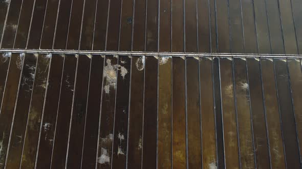 Aerial birdseye flying forward over salt fields structure, Vietnam alt