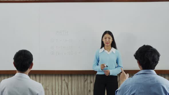 Young asian teacher teaching students at classroom.