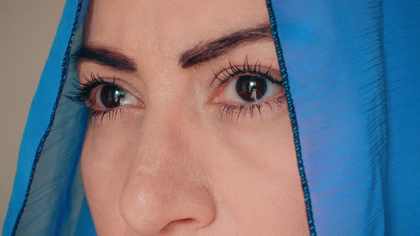 Black-eyed woman in headscarf 