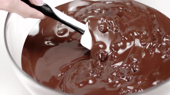 Chef Melts Dark Chocolate Couverture Callets in Glass Bowl Slow Mo Close Up