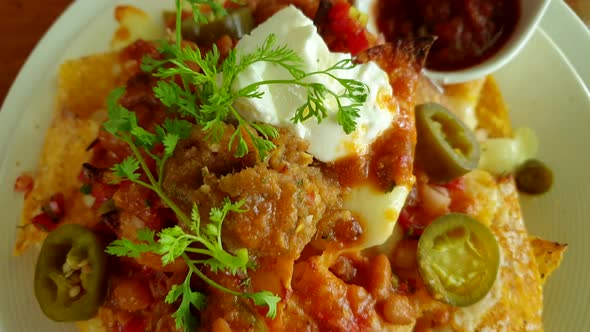 Mexican Food Appetizer Nachos With Salsa And Cheese Sour Cream And Corn Tortilla Chips Top View