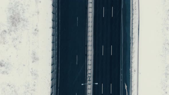 Aerial View Vertically Down the Highway in Winter, Cars Drive Along the Road alt