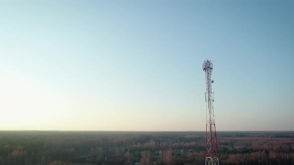 Communication Tower on the Background of the Evening Sky in Autumn alt