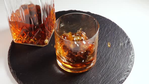 Ice Cube Falls into a Glass of Whiskey