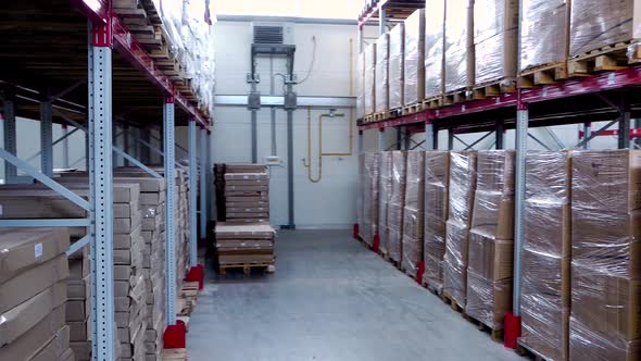 Rows of Shelves with Boxes in Modern Warehouse