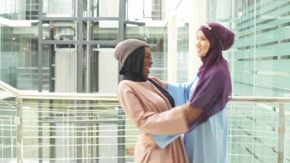 Meeting Two Longtime Friends Dressed in Traditional Clothes. Two Muslim Business Women Met in a