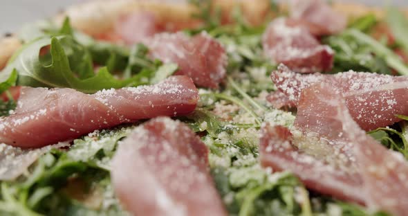 Close Up Pizza with Prosciutto Parma Ham Arugula Salad Rocket with Ingredients alt