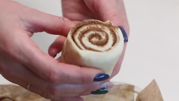 A Woman Puts Sliced Dough With Cinnamon Into A Baking Dish For Baking Cinnabons. Close Up Shot alt
