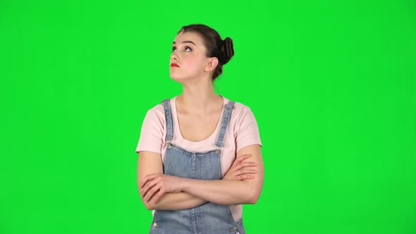 Lovely Girl Listens Carefully To Boring Information and Looks Around on Green Screen alt