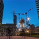 Cranes building skyscrapers at night with people in Milan, Italy, timelapse, 4k - VideoHive Item for Sale
