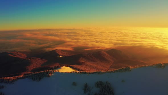 Flyover winter mountains. Golden morning Sunrise. Beautiful Aerial Nature landscape