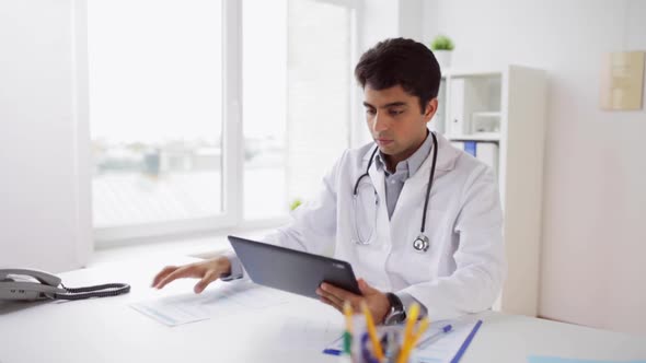 Doctor with Tablet Pc and Papers at Hospital 10 alt