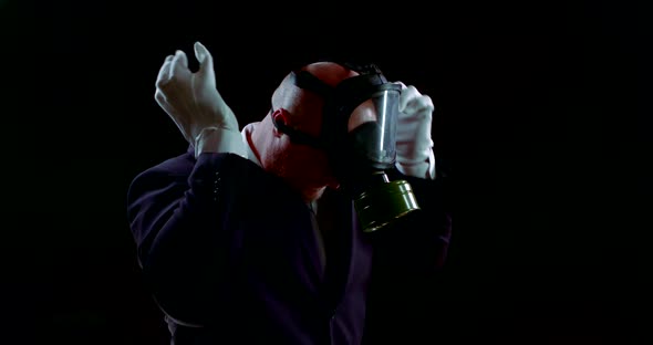 Face of a Person in a Business Suit Wearing a Gas Mask on a Black Background That Protects Against alt