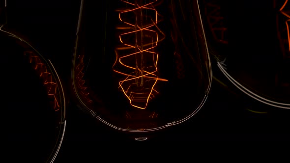 Extreme Close Up Three Tungsten Old Edison Retro Lamp Turn On. Light Bulb Threads Are Shaking. Light alt
