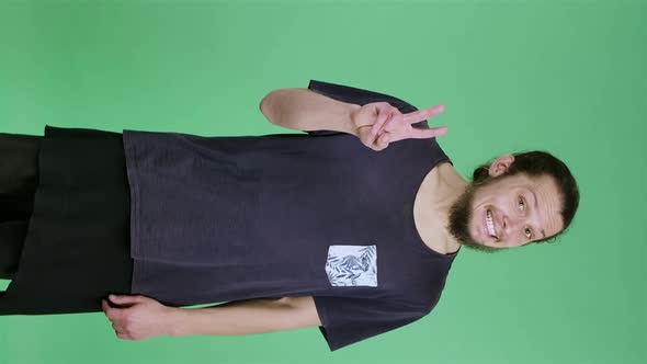 Portrait of a Man Shows a Victory Gesture with Two Fingers alt