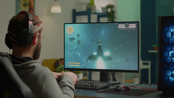 Pro Man Gamer Playing Video Game at Powerful Personal Computer Late Night alt