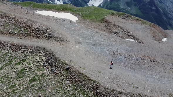 Aerial View of Young Woman Walking in Highlands alt
