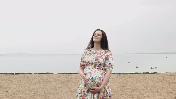 Happy Pregnant Woman Caress The Belly