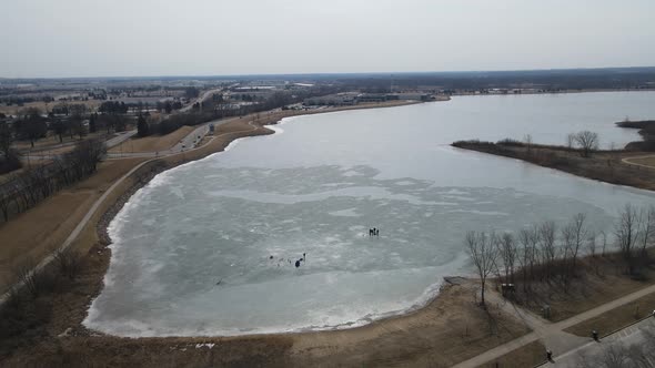 Bird view of frozen lake with ice fishermen and shanties set up in Kenosha, Wisconsin.