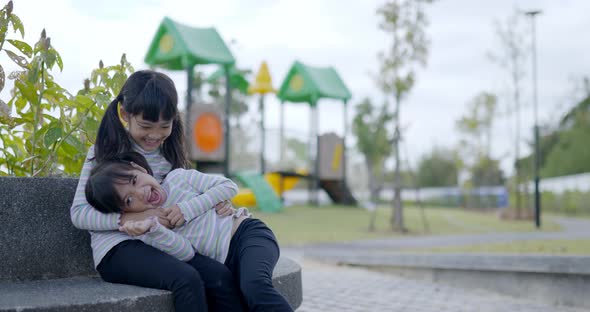 Attractive two lovely girls have fun while playing together alt