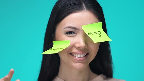 Happy Female With Sticky Notes, Learning Body Parts in Spanish, Education alt