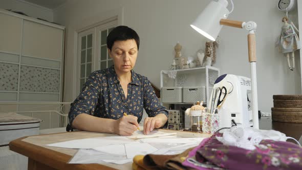 Woman working with sewing patterns alt