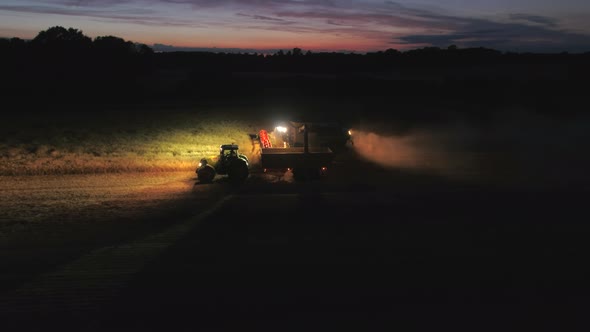 Combine Harvester at Night During the Harvest alt