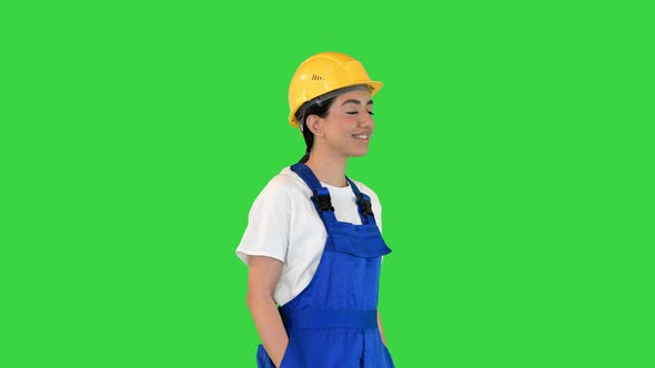 Young Beautiful Worker Woman Wearing Security Helmet on a Green Screen Chroma Key