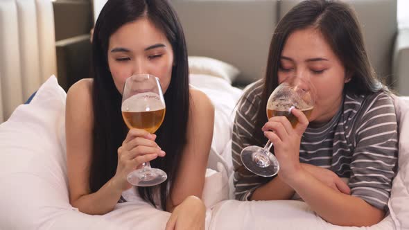 Asian lgbt lesbian couple lying on bedroom alt