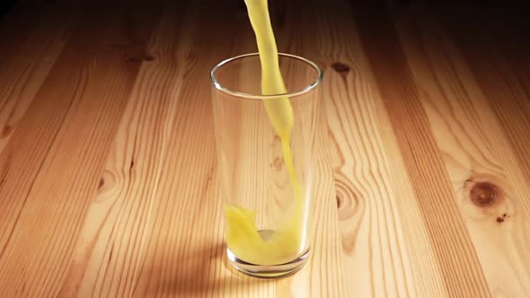 Juice Poured into a Glass with Splashes