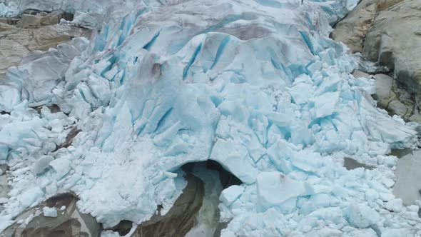 Blue Melting Nigardsbreen Glacier Is Arm of Jostedalsbreen in Norway. Big Ice Blocks. Aerial View alt